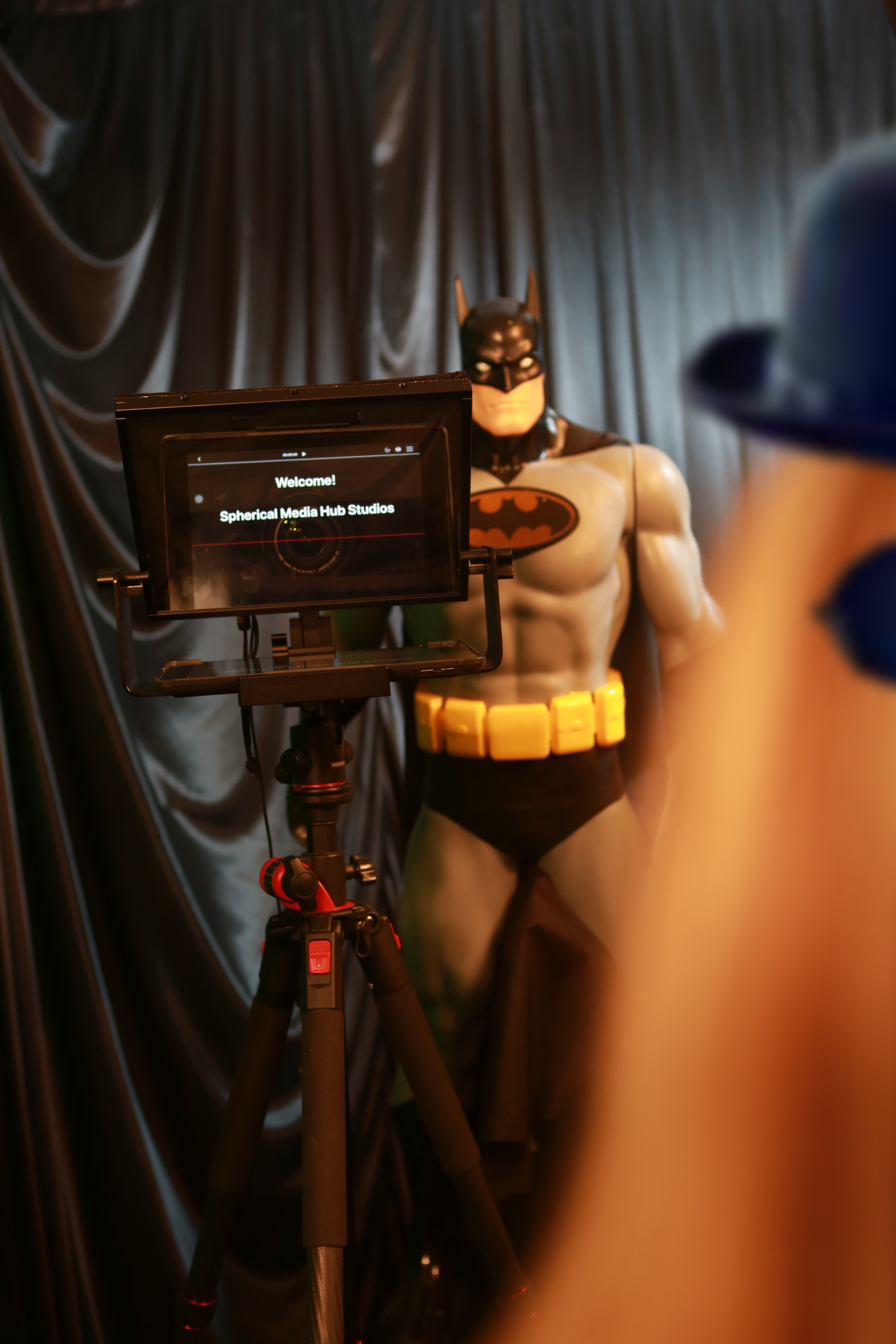 Batman and cousin It using the teleprompter.